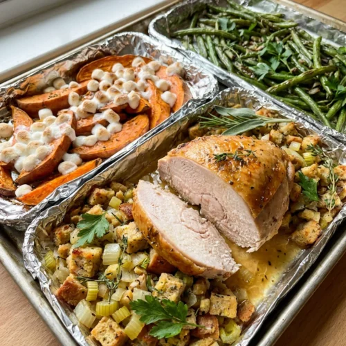 A white plate holding a complete serving of sheet pan Thanksgiving dinner.